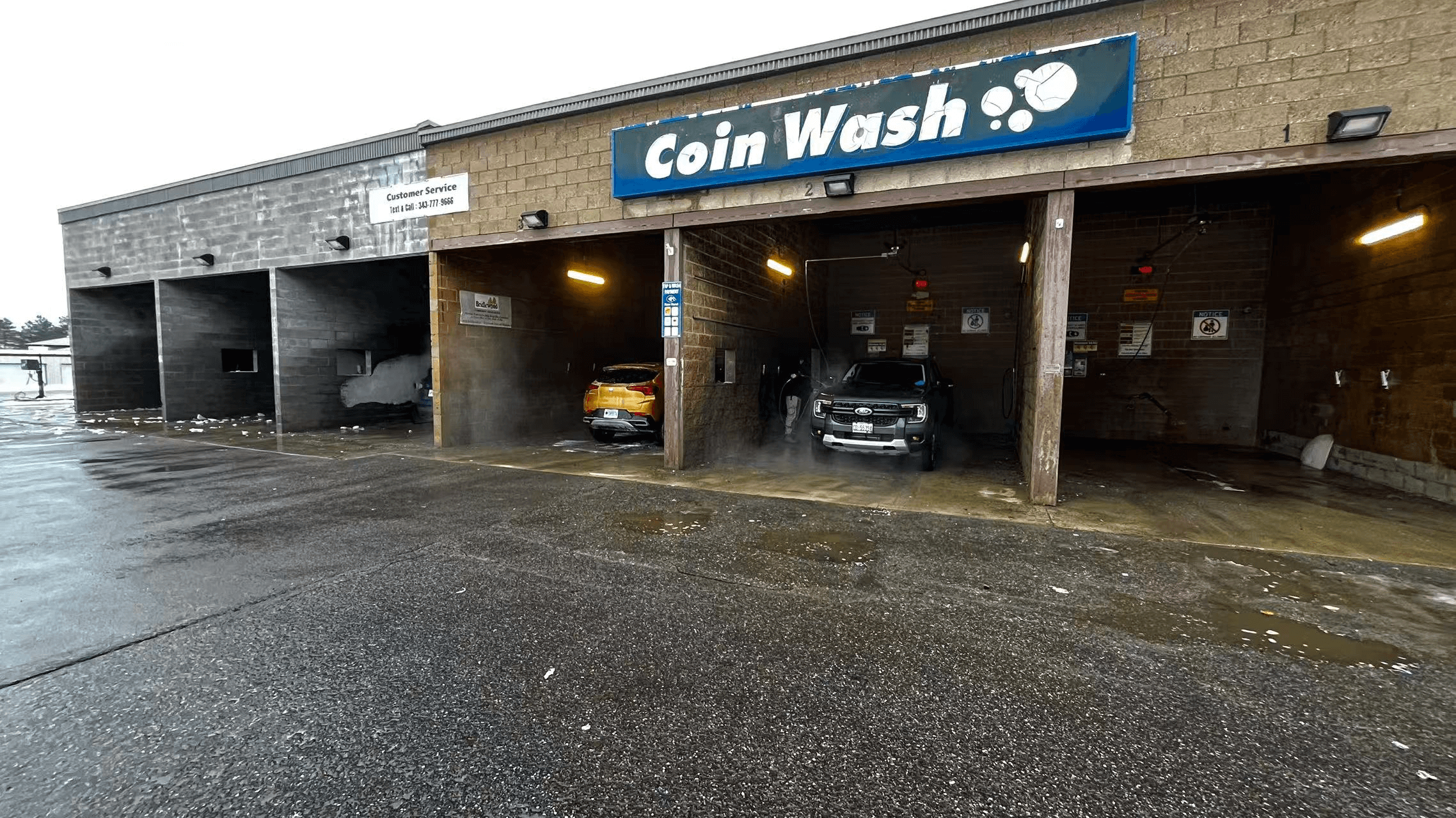Car wash facility exterior showing 6 self-service bays